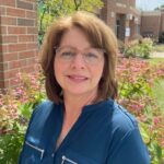 Middle-aged woman with brunette hair and glasses. Deals with effective parenting techniques.